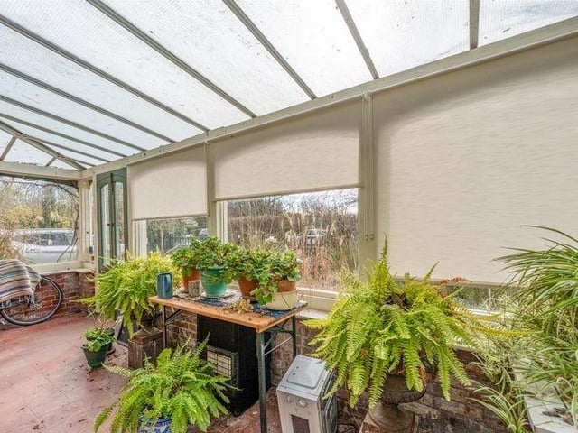The property retains many original features, including this delightful conservatory