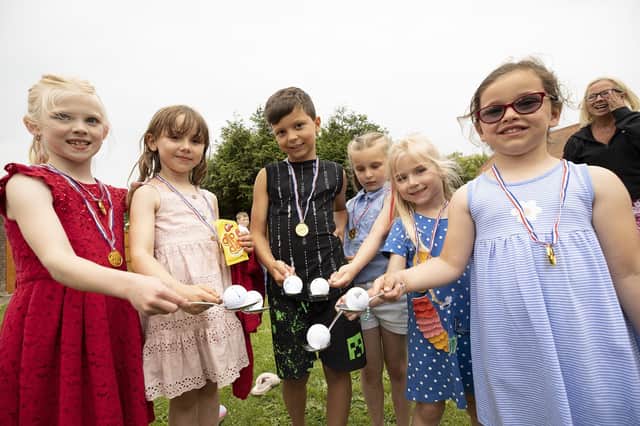 Children from the Manor Farm Close estate after taking part in an egg and spoon (golf ball), race, as part of a day of games and bbqs held in Selsey.