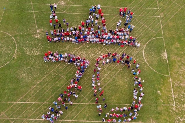 The whole school gathered on the field to have a photograph taken by videographer Terry Fay