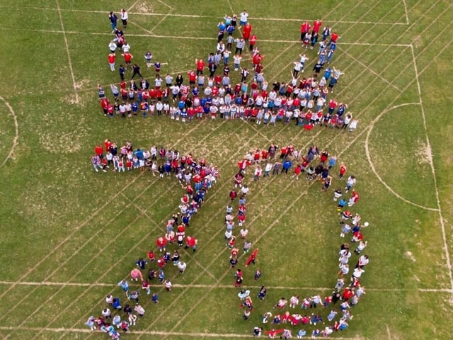 The whole school gathered on the field to have a photograph taken by videographer Terry Fay