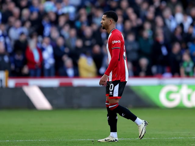 SHEFFIELD, ENGLAND - FEBRUARY 18: Mason Holgate of Sheffield United looks dejected after being red carded after a VAR review during the Premier League match between Sheffield United and Brighton & Hove Albion at Bramall Lane on February 18, 2024 in Sheffield, England. (Photo by Matt McNulty/Getty Images)