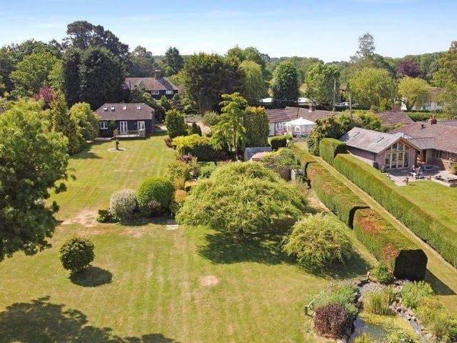 Adjacent to the main property on two sides are well paved terraces, one with a raised ornate fish pond.