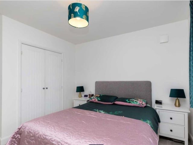 There are three bedrooms, two of which are doubles both with fitted wardrobes, while the main bedroom has a well-equipped en-suite shower room with a walk-in shower, wash hand basin and a low-level WC.