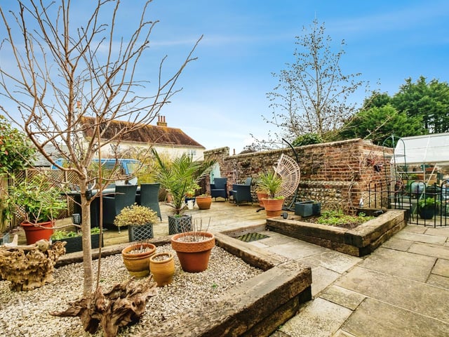 Outside, the secluded gardens feature areas of lawn, raised beds with timber sleepers, a timber decking area and a wildlife pond