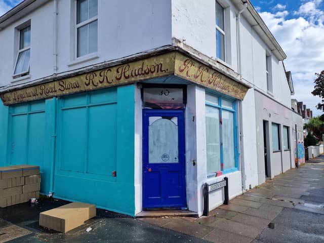 The sign for The Lyndhurst Road Stores, run by R.K. Hudson family grocer, has been uncovered