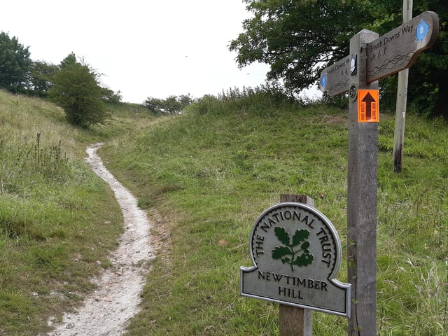 Follow the path up Newtimber Hill, with ancient woodland, chalk grassland and long-reaching views of the sea and across the Weald