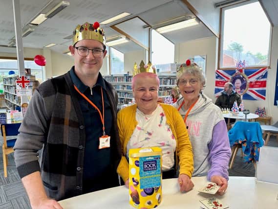 1000th Member Sue – centre –  who won a £20 book token and chocolate egg, with library volunteers Phillip and Marilyn