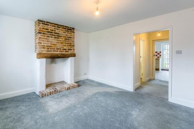 The sitting room is completed with a brick hearth.