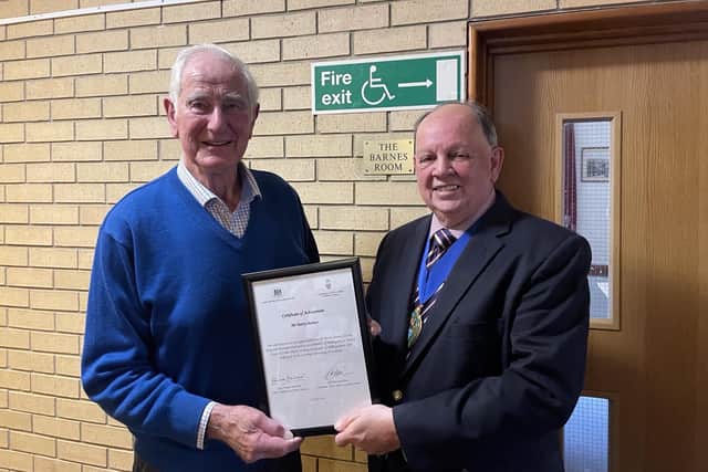 West Sussex County Council chairman Pete Bradbury presents long-serving parish councillor Barry Barnes with a Certificate of Achievement after 55 years continuous service to his community.