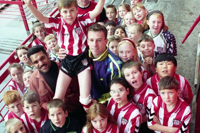 Sunderland AFC donated two full sets of Sunderland football kit to Harraton School in 1992. Here is school team Darren Young being carried shoulder-high by Don Goodman and Kevin Ball.