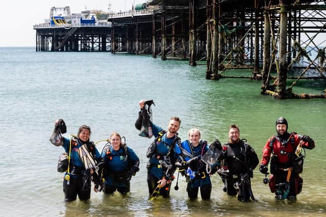 Beach cleaners collecting litter near the Brighton pier 
