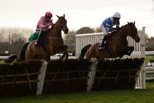 Brewin'upastorm (nearside) on the way to another National Spirit Hurdle win at Fontwell Park | Picture: Clive Bennett