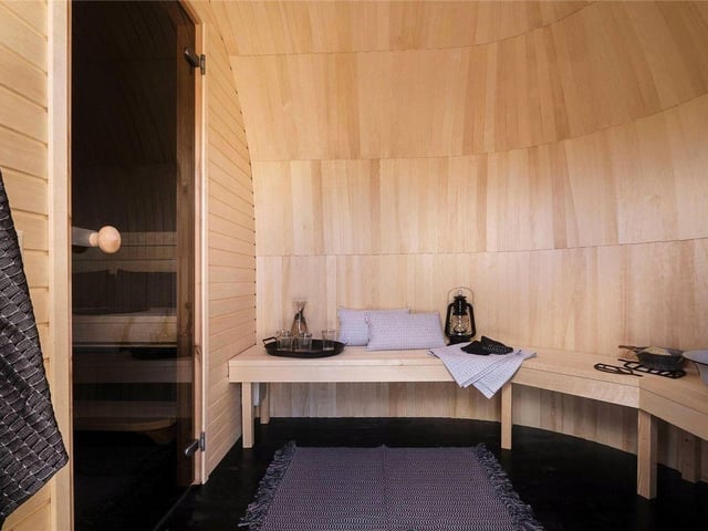 A separate pod houses an electric sauna, complete with changing space