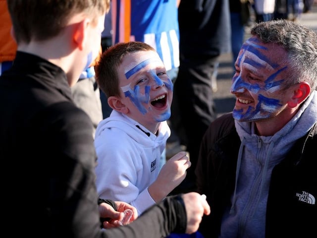 BRIGHTON, ENGLAND - NOVEMBER 13: A family of Brighton & Hove Albion fans apply face paint outside the stadium prior to the Premier League match between Brighton & Hove Albion and Aston Villa at American Express Community Stadium on November 13, 2022 in Brighton, England. (Photo by Christopher Lee/Getty Images)