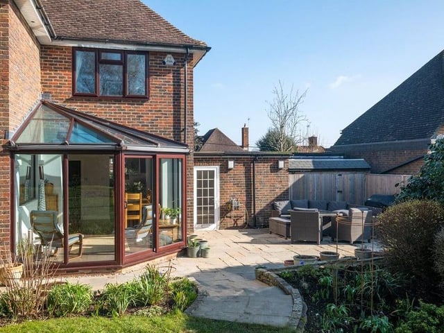 The rear garden has an Indian sandstone patio, a Victorian style orangery, a raised-bed vegetable garden and landscaped herbaceous borders