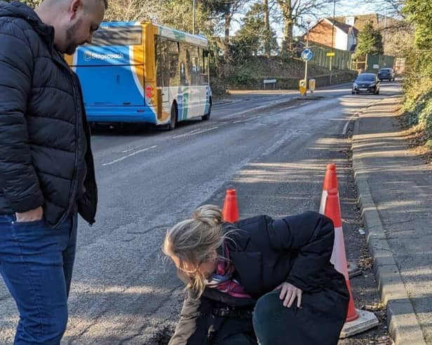 Sally-Ann inspecting a local pothole 