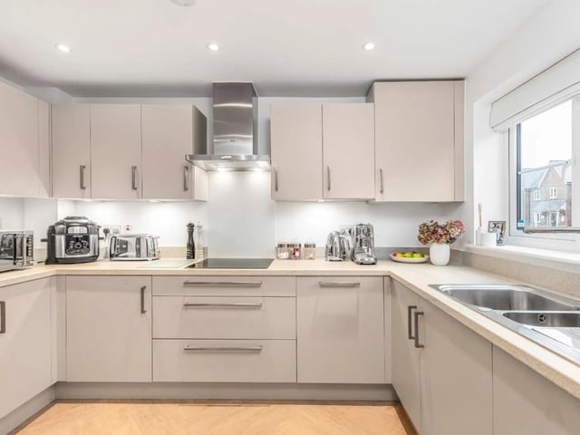 The front-facing kitchen boasts modern fitted units