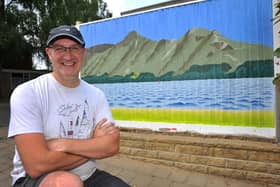 Marc Ellis has painted a mural of a Lake District scene on a fence outside his house in Horsham. Pic S Robards SR2207191