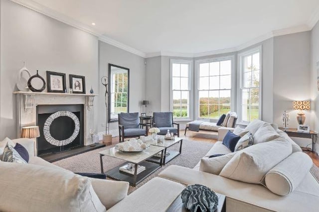 The ground floor accommodation is complemented by a fabulous 25 foot long drawing room with a marble fireplace and floor to ceiling, south-facing sash windows overlooking the garden.