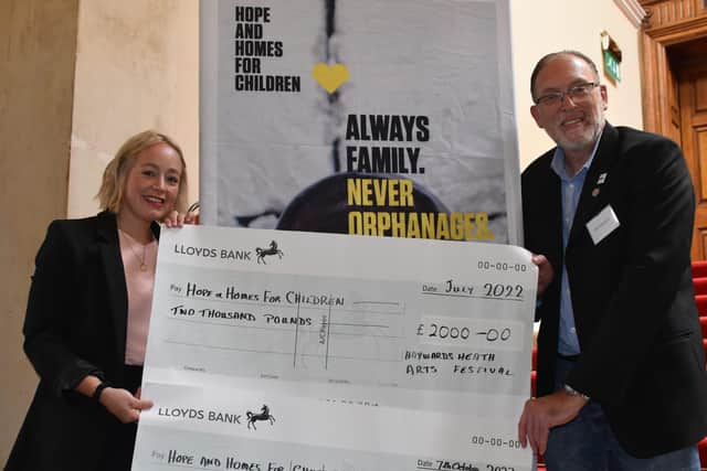 Festival committee member Colin Kenward presents donations raised from the Haywards Heath Arts Festival to Catherine Butt, Fundraising Manager of Hope and Homes For Children.  