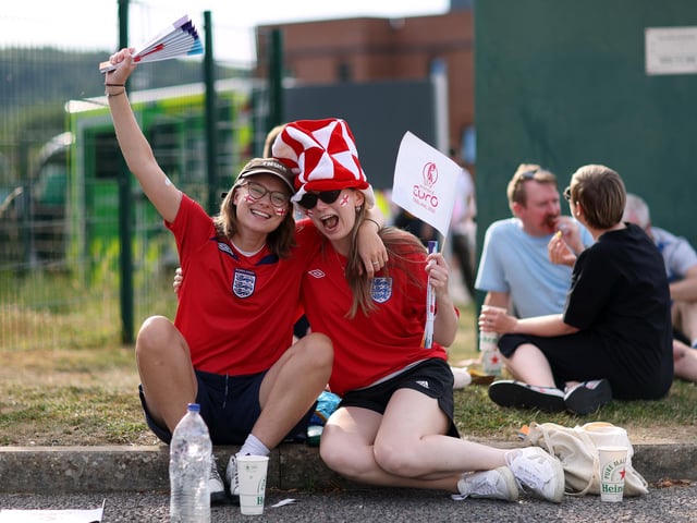 England fans pose for a photo outside the stadium.
