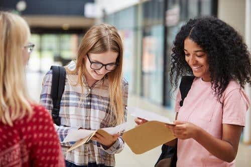 College Students Opening Exam Results. Photo from Shutterstock. Submitted by Cranleigh School