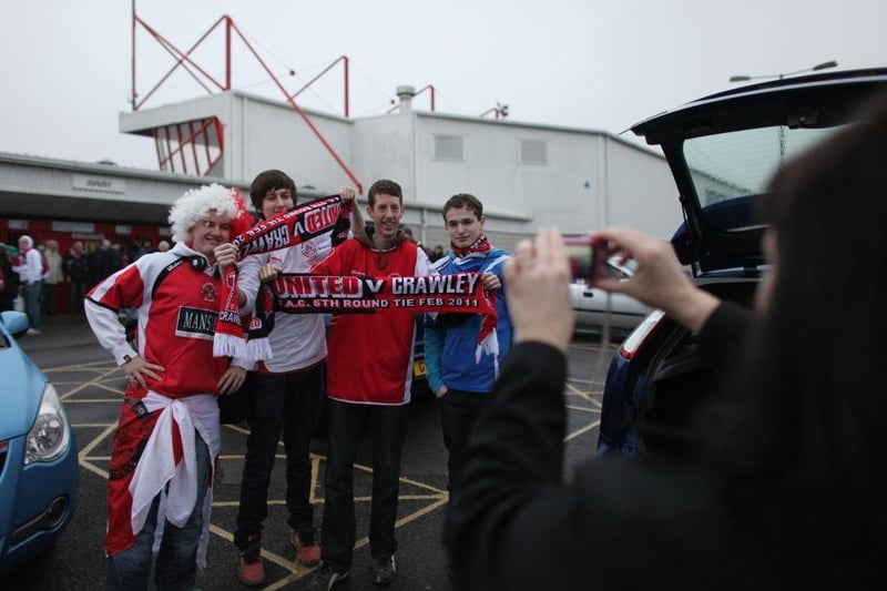 Fans Crawley Town have their photo taken before boarding coaches to Manchester.