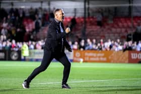 Crawley Town boss Scott Lindsey celebrates in front of the fans after the MK Dons win at the Broadfield Stadium. Picture: Eva Gilbert