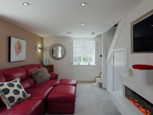 The Southwell property is tailormade for relaxing in front of the telly. This is another of the reception rooms, being used as a lounge. The staircase in the background leads to the first floor.