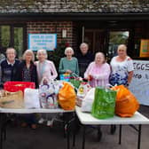 Head Suzannah Cryer and children from Highfield and Brookham School deliver the harvest goodies