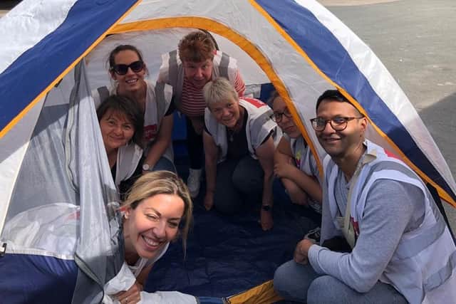 Sharon Mitchell, at the back of the tent, volunteering with Calais Light