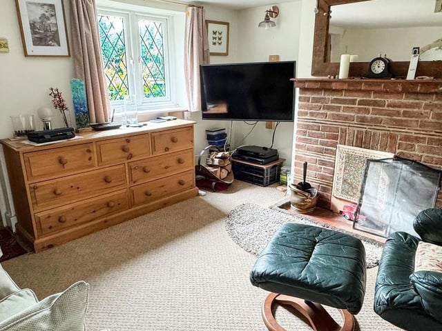 The entrance porch, with space for coats and shoes, opens into a welcoming living room with fireplace