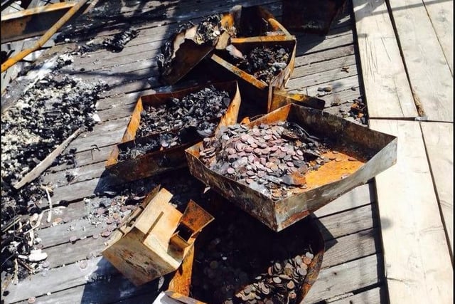 Strongboxes containing cash from the burnt out arcade at Eastbourne Pier are cleared away by contractors