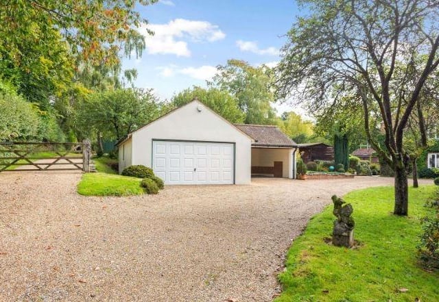 Built in 1996, the detached garaging comprises a tandem double garage with power connected, electronically-operated up and over door, fitted workbench and rafter storage, and an adjoining double carport.
