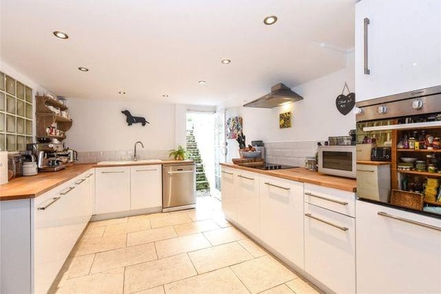 The dining room opens through to a modern, comprehensively fitted kitchen with a built-in oven and hob.