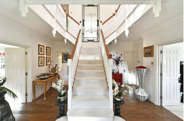 There is a grand, vaulted entrance hall with a central staircase