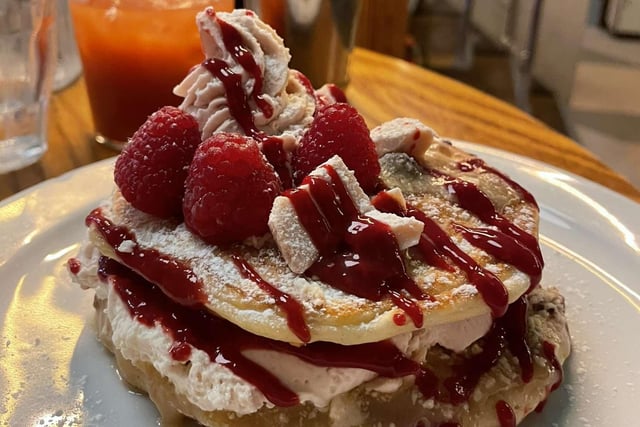 The Phantom Raspberry Blower Of Old London Town is inspired by Tony’s Strawberry Cheesecake & Raspberry White Chocolate bar. Fresh raspberry pancakes, with a berry ripple cheesecake mix, topped with raspberry cream & coulis, melted Tony’s white chocolate and finished with fresh strawberries & raspberries.