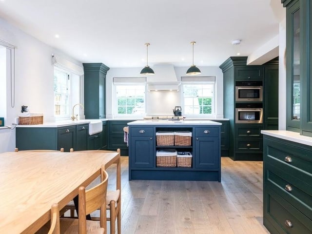 The hand-fitted kitchen has an island and a built-in pantry