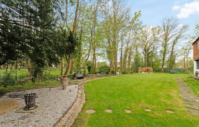 Outside are attractive gardens of 0.391 of an acre which surround the property to all sides and flanked by paddocks. The beautiful grounds include established mature plants and trees along with a brick built well which has been re-instated as a feature. Double gates lead to a private parking area and there is a tandem garage and store to the side.