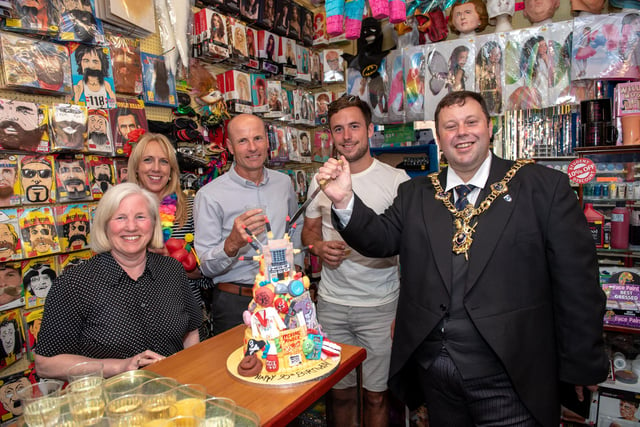 Lord Mayor Cllr Lee Mason prepares to cut the anniversary cake with the owners and staff of the shop as U-Need-Us celebrated its 95th anniversary in 2018. Picture: Vernon Nash (180396-007)