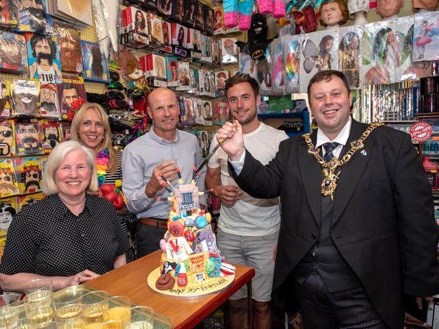 Lord Mayor Cllr Lee Mason prepares to cut the anniversary cake with the owners and staff of the shop as U-Need-Us celebrated its 95th anniversary in 2018. Picture: Vernon Nash (180396-007)