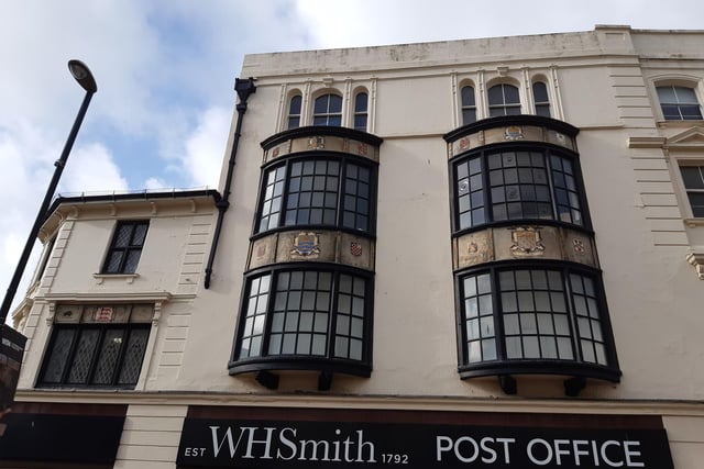 Decorative stained-glass windows and heraldic crests above W.H. Smith date back to a café that opened there in 1928