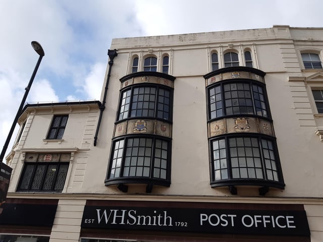 Decorative stained-glass windows and heraldic crests above W.H. Smith date back to a café that opened there in 1928