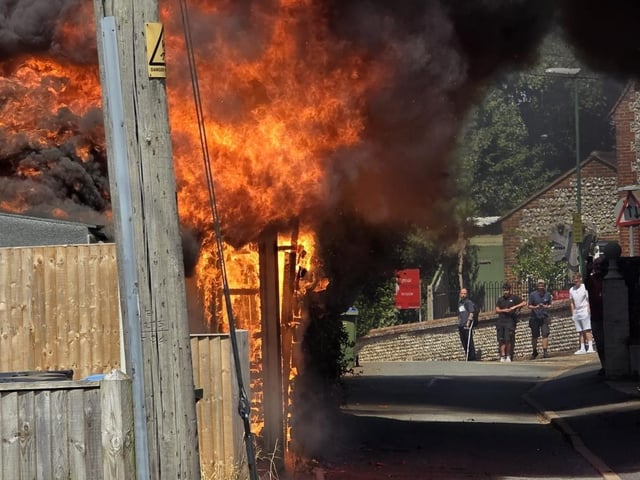 Firefighters tackle a blaze that destroyed two sheds, on Beaconsfield Road