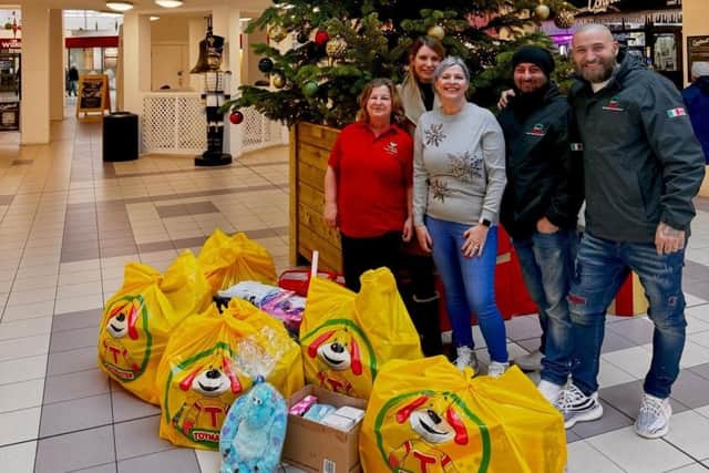 Melanie Peters with the gifts bought from Toy Barnhaus after the Christmas toy appeal at Enzo's Italian restaurant