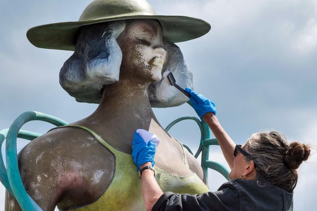 Volunteers help restore the sculpture. Picture by Lineker Photography