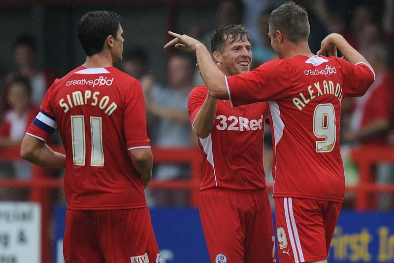 Billy Clarke (C) of Crawley Town celebrates scoring the opening goal with team-mate Gary Alexander during the pre season friendly match between Crawley Town and Crystal Palace at Broadfield Stadium on July 27, 2013.