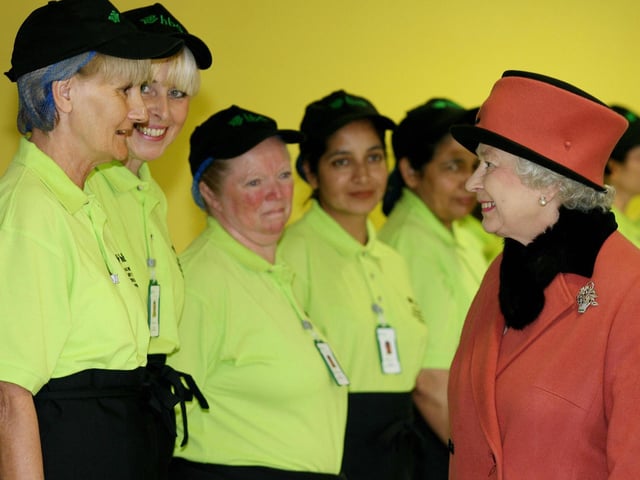 Queen Elizabeth II meets the dinner ladies at the Thomas Bennett Community College in Crawley. AFP PHOTO/Gareth Fuller/WPA ROTA