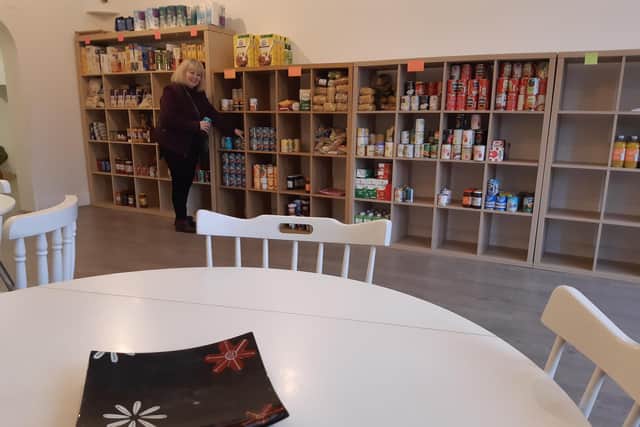 Margaret Howard stacking shelves in the new community pantry