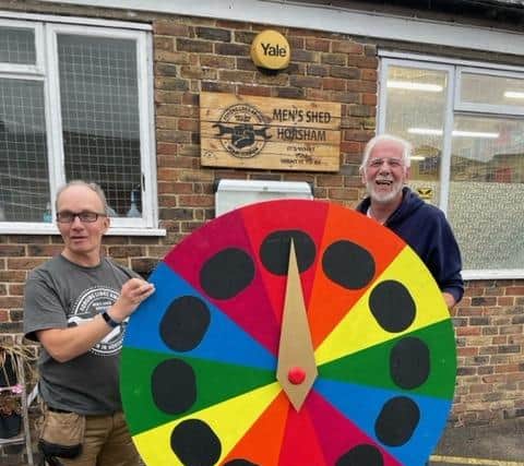 Some of the members of Horsham's Men's Shed with the Wheel of Fortune they created for Castlewood Primary School in Southwater